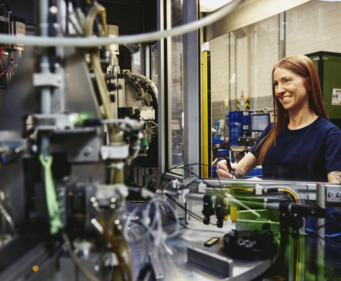 Woman operating a machine on a production site. 